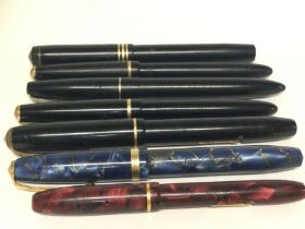 A collection of vintage gold tipped pens including