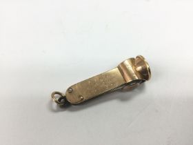 An 18ct gold cigar cutter, approx 10.5g. Shipping