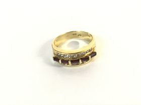 An 18ct gold ring set with baguette cut rubies fla