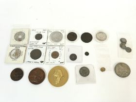 A collection of tokens and small replica coins. Po