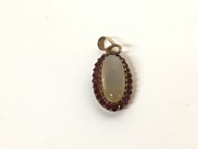 9ct gold pendant set with Rubies and moonstone. Ap