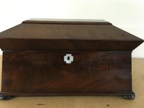 A Victorian mahogany tea caddy the hinged lid encl