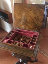 A Victorian walnut workbox with a well fitted inte