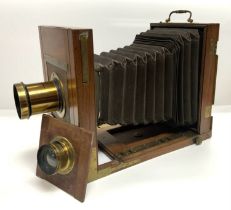 A Mahogany folding plate camera with 2 detachable
