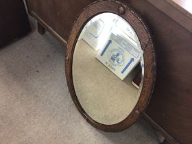 An oak framed oval mirror 79x59cm and an inlaid ba