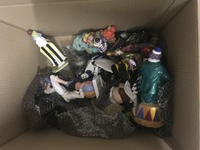 A box of ceramic clown figures and clown toys.- NO