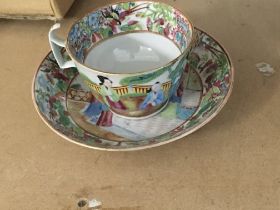 A canton cup and saucer decorated with figures flo