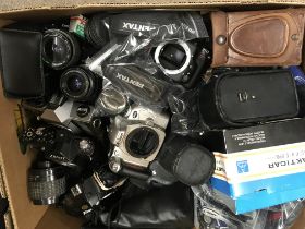 A box containing cameras ,parts ,lenses various