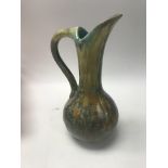 A French pottery pierrefonds glazed jug. Height ap