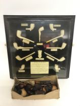 A display case featuring Traditional clay pipes an