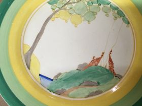 A Clarice Cliff plate decorated with house and tre