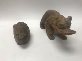 Two detailed wooden hand carved Canadian animals.