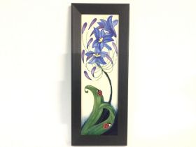 A framed Moorcroft wall plaque. 36cm by 14cm. Post