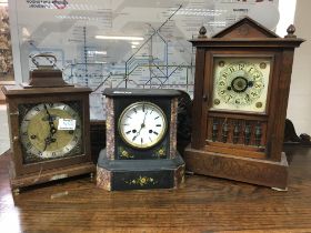 A slate mantle clock with Roman numerals and two o