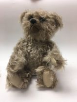 A boxed Steiff grizzly teddy bear.