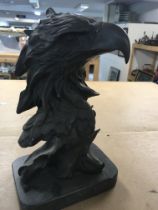 A bronzed sculpture in the form of a eagles head .