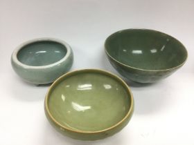 Three celadon bowls, largest diameter approx 17.5c