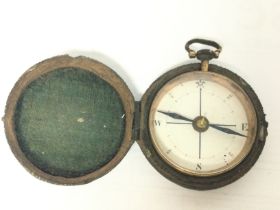 A small vintage compass with a fitted stingray ski