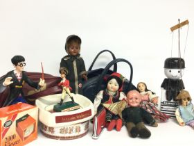 An assortment of items including dolls, puppets, b