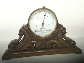 A carved walnut barometer stand with attached Baro