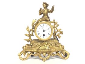 A Victorian Gilt mantle clock with key and pendulu