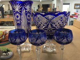Two blue cut glass vases and three matching glasse