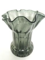 A large art deco style coloured black glass flower