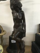 A bronzed figure in the form of a classical maiden