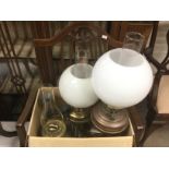 A collection of oil lamps and a pair of wrought ir