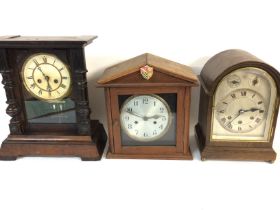 Three oak mantle clocks. Postage D.