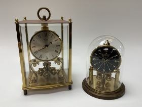 A vintage brass Kundo Quartz clocks together with