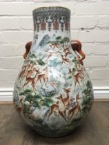 A Chinese bulbous floor vase decorated with numero