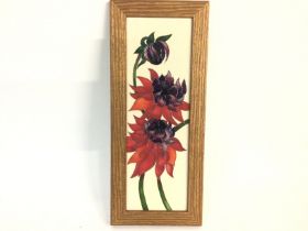 A framed Moorcroft wall plaque. 35cm by 14.5cm. Po