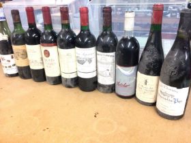 A collection of 10 assorted bottles of red wine in