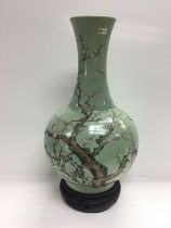 A large celadon vase decorated with prunus blossom