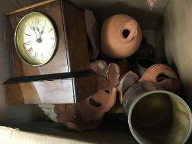 A box containing a small Walnut mantel clock small items of treen terracotta wall masks and