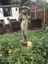 A weathered composition garden ornament in the for