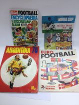 A collection of football sticker books comprising