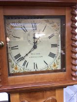 A 30 hour long case clock the painted dial with Roman numerals. Wilson Chichester