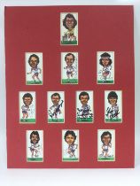 A mounted presentation of football cards signed by