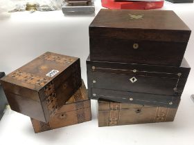 A collection of five wooden boxes, including two w