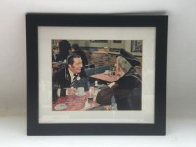 A framed and glazed signed photo of Reg Varney as