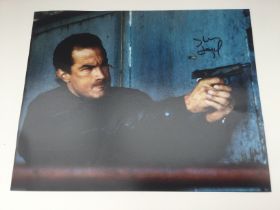 An unframed signed photo of Steven Seagal, approx