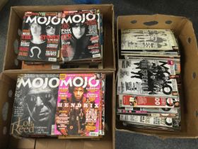 Three boxes of Mojo music magazines.