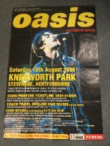 A bus stop poster advertising the legendary Oasis