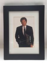 A framed and glazed signed photo of Tom Jones, app