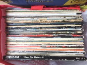 A collection of rock LPs by various artists includ