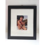 A framed and glazed signed photo of Jackie Chan, a