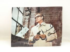 An unframed signed photo of Michael Caine as Harry
