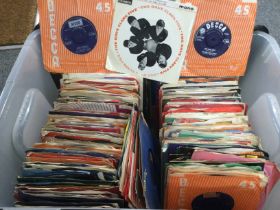 A plastic box of 7inch singles and EPs by various